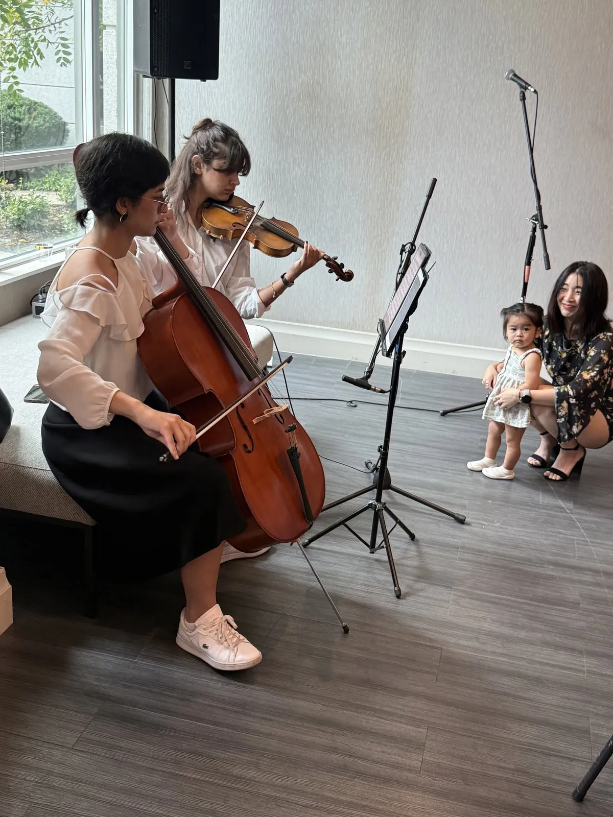 Violin and cello duo performing live for guests at a wedding ceremony