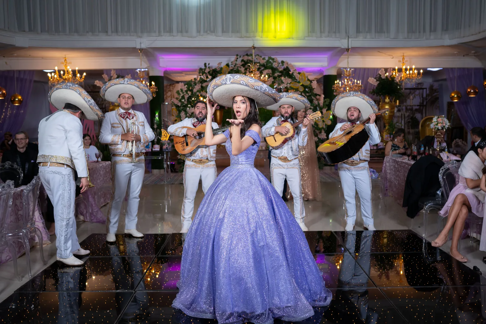 Mariachi band performing for a guest of honour on a mirrored dance floor